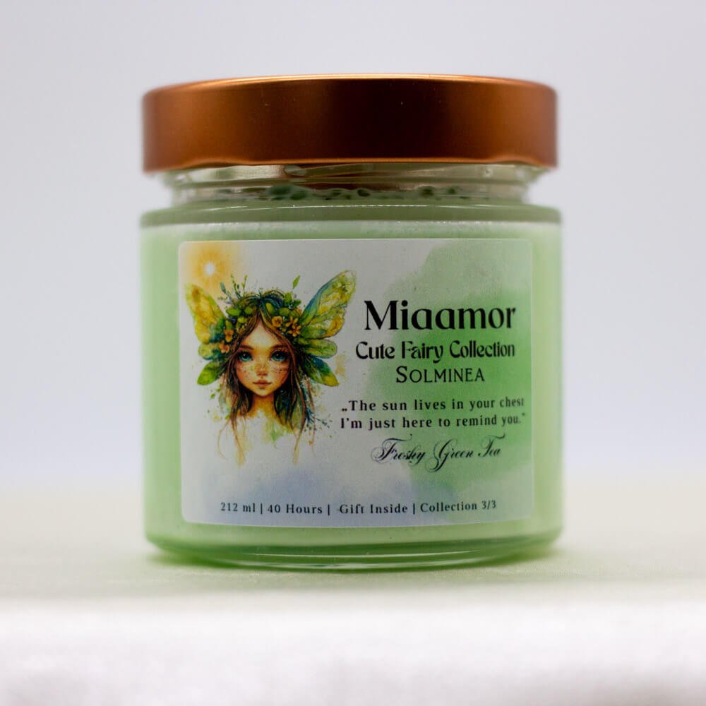 Solminea candle with peridot and green aventurine crystals on top, sparkling with light and surrounded by fresh greenery.